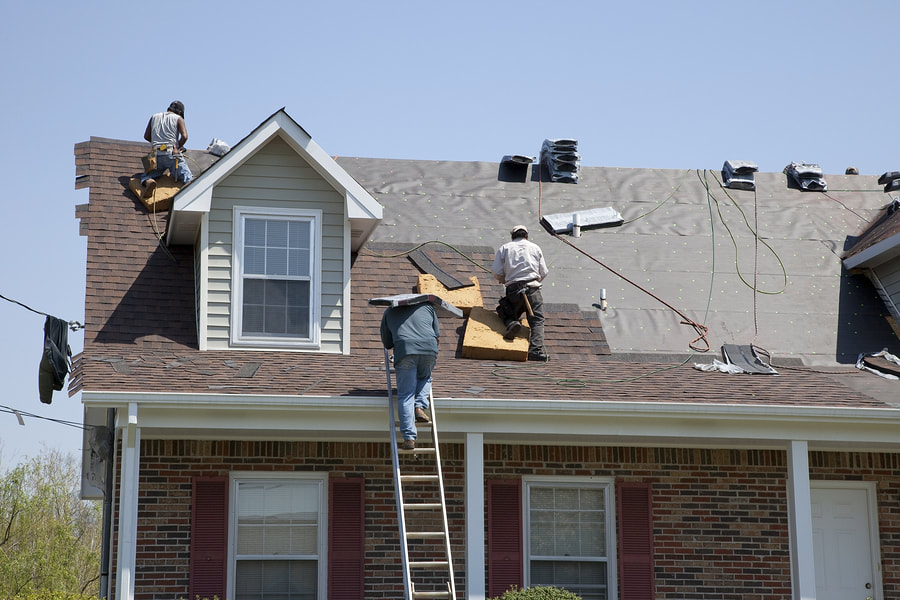 construction workers doing re-roofing