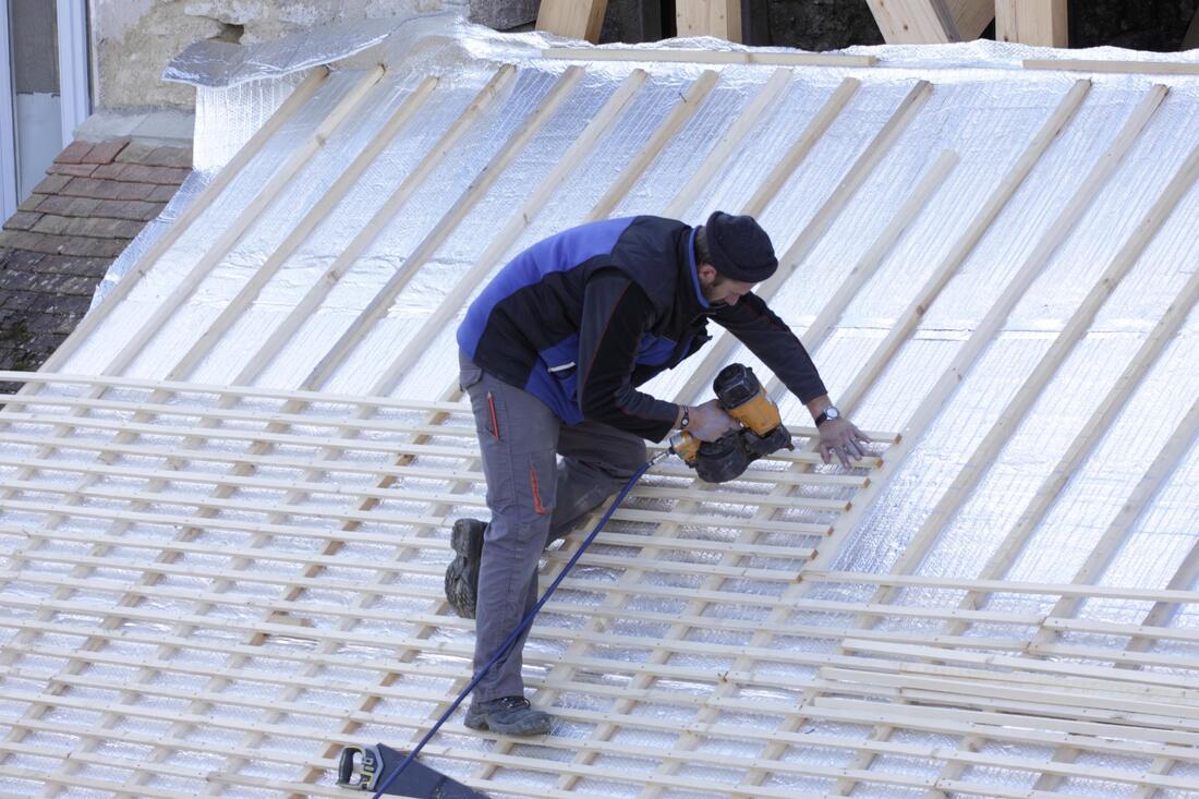 construction worker installing roof