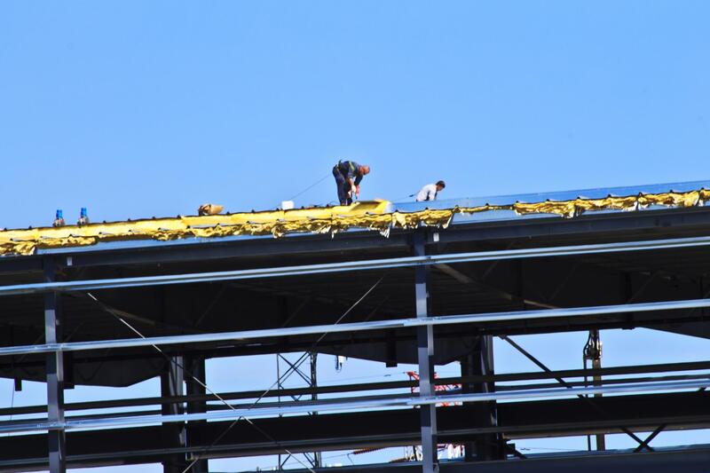 construction workers on top of roof
